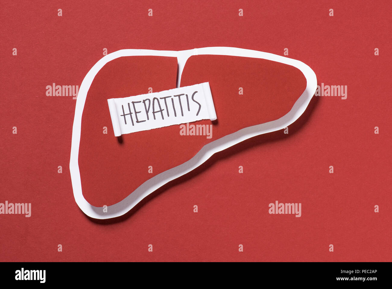 Hepatitis Lettering top view of liver and lettering hepatitis on red background, world ...