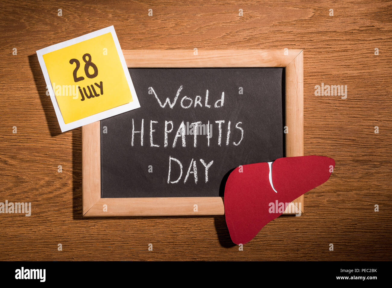 Hepatitis Lettering top view of blackboard with lettering world hepatitis day, liver and ...