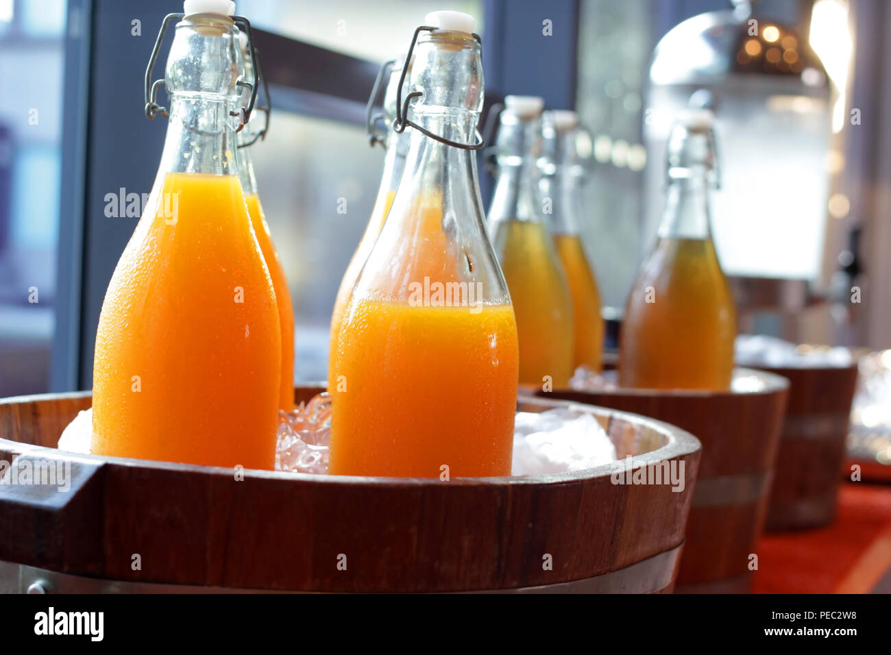 https://c8.alamy.com/comp/PEC2W8/orange-juice-and-water-in-bottles-on-buffet-line-PEC2W8.jpg