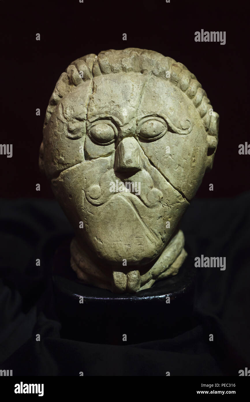 Celtic head from Mšecké Žehrovice on display at the exhibition devoted to the Celts in the National Museum (Národní muzeum) in Prague, Czech Republic. The cretaceous limestone head dated from the 3rd century BC found in 1943 is considered as one of the best examples of the Celtic sculpture. The exhibition presenting the Iron Age artefacts of the La Tène culture runs till 24 February 2019. Stock Photo