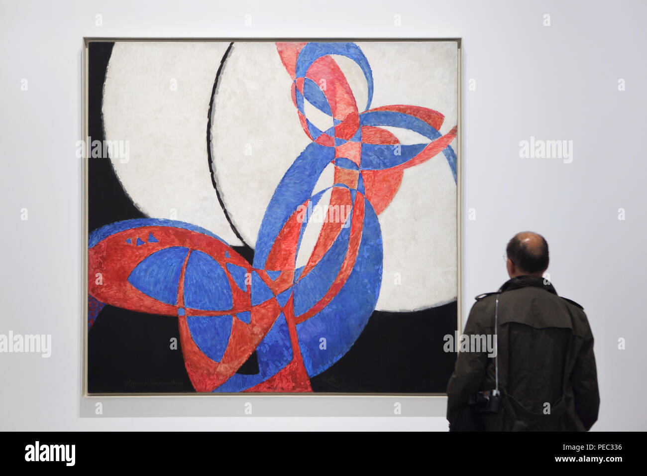 Visitor in front of the painting 'Amorpha: Fugue in Two Colours' by Czech  modernist painter František Kupka (1912) displayed at his retrospective  exhibition in the Grand Palais in Paris, France. The exhibition