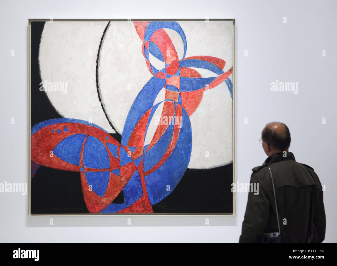 Visitor in front of the painting 'Amorpha: Fugue in Two Colours' by Czech modernist painter František Kupka (1912) displayed at his retrospective exhibition in the Grand Palais in Paris, France. The exhibition runs till 30 July 2018. Stock Photo