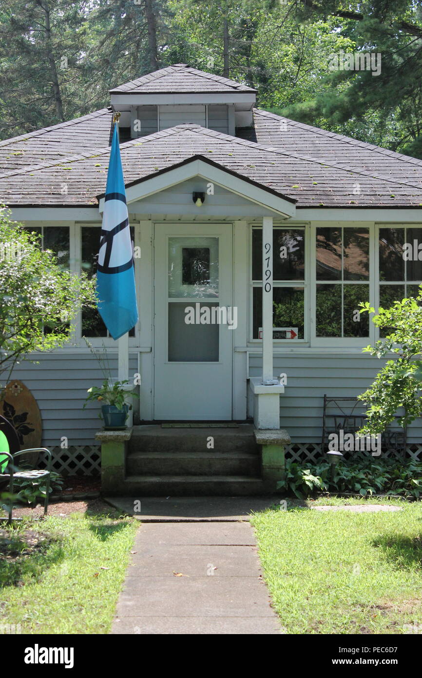 Summer cottage with a blue peace flag hanging in front of the house in