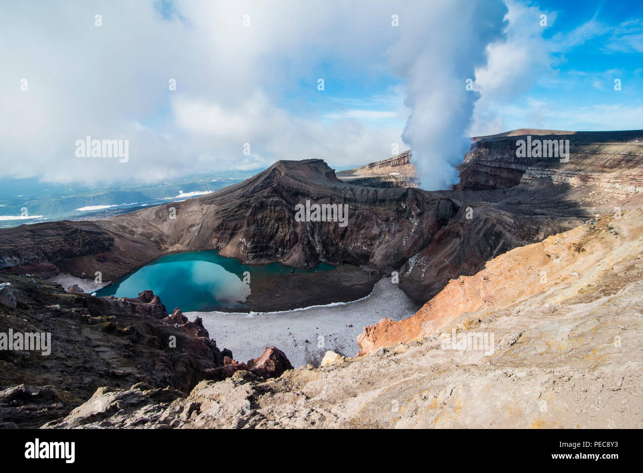 Steaming fumarole with crater lake on the Gorely volcano, Kamchatka, Russia Stock Photo