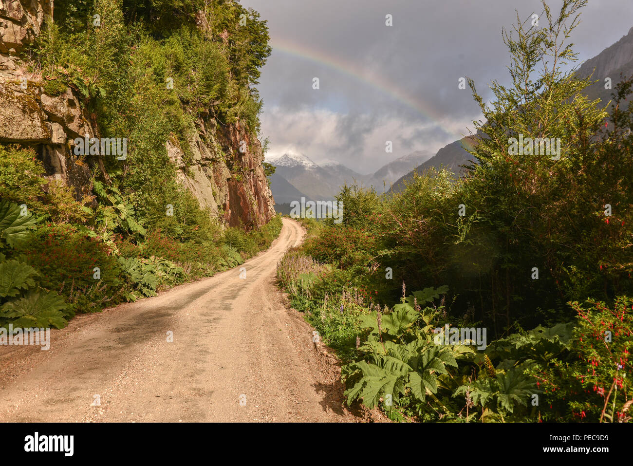 Gravel road with rainbow at Puerto Río Tranquilo, Carretera Austral, Valle Exploradores, Patagonia, Chile Stock Photo