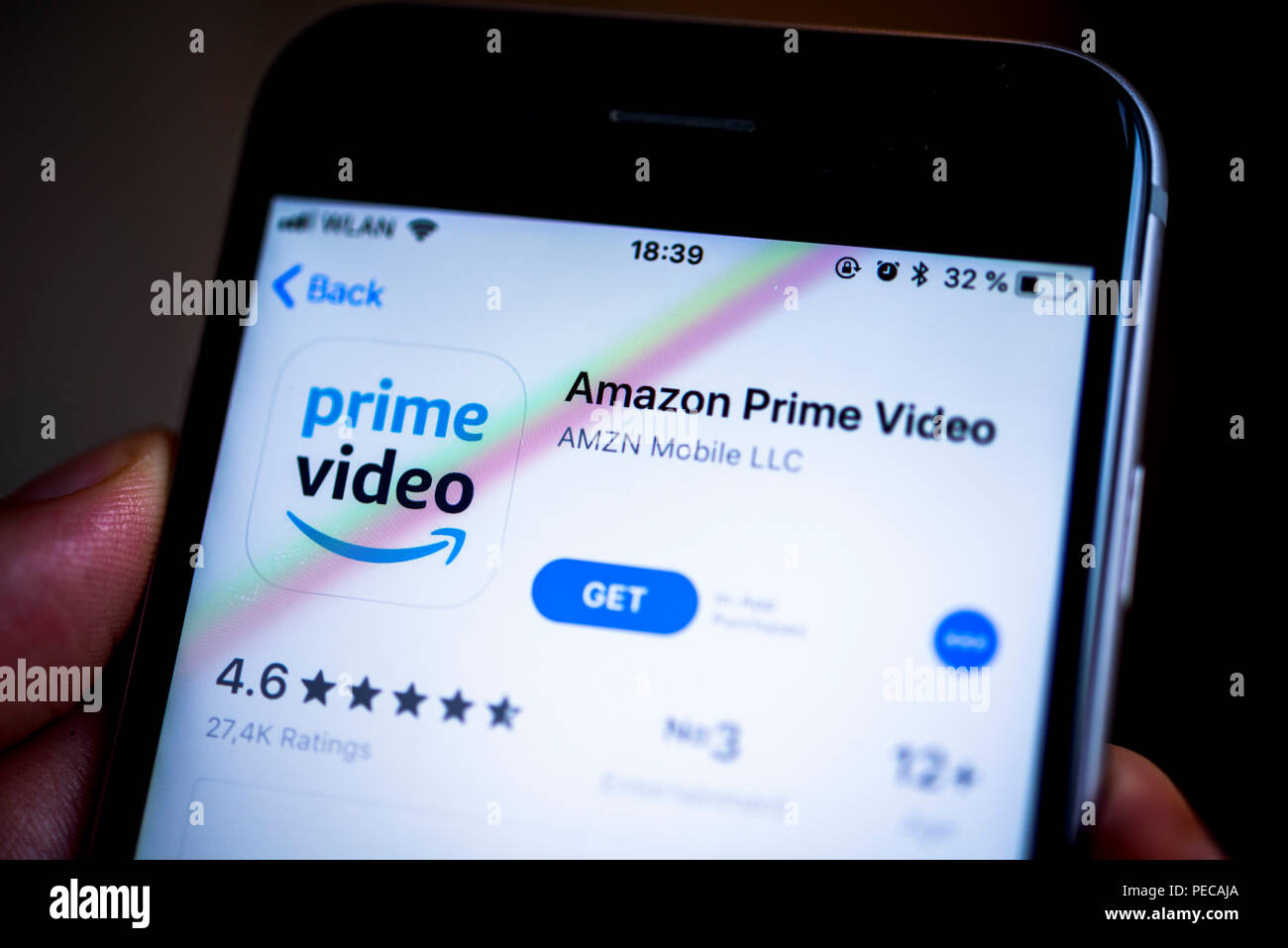 Hand holding iPhone with Amazon Prime Video App in the Apple App Store, video streaming service, app icon, iPhone, iOS Stock Photo