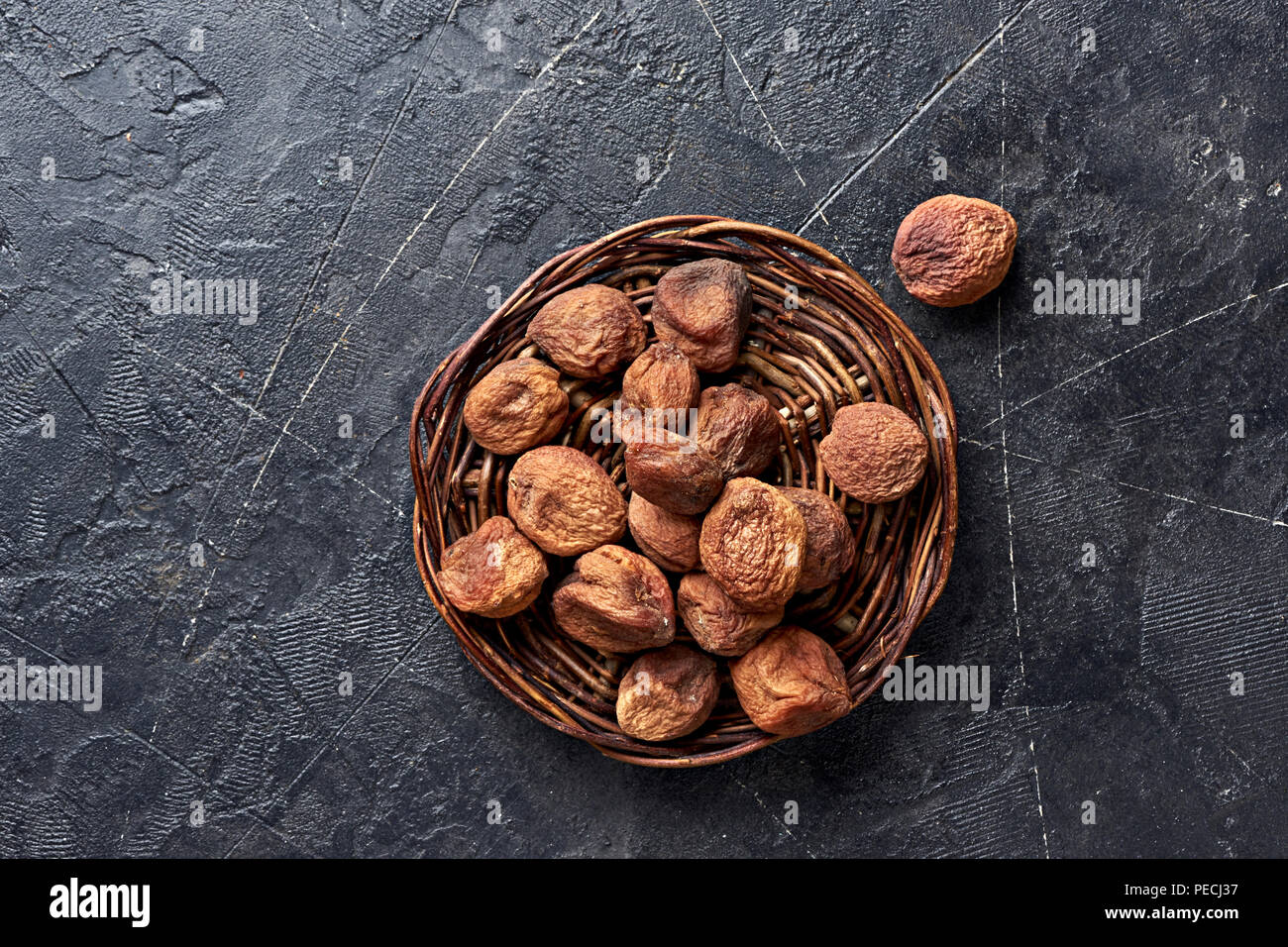 Sun dried apricots on gray background. Top view. Stock Photo
