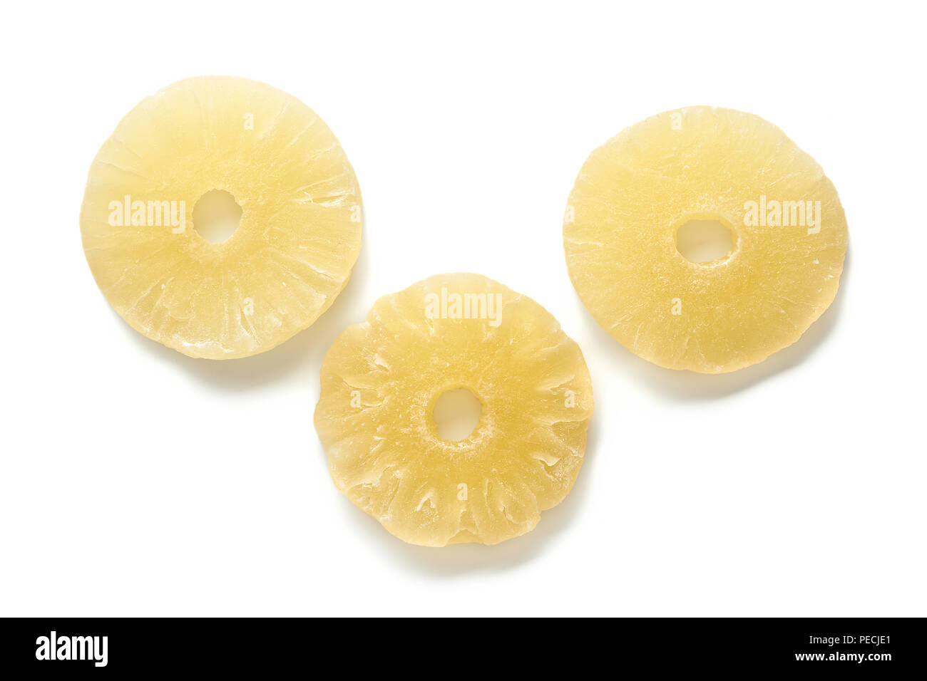 Sweet dried pineapple rings isolated on white background. Top view of