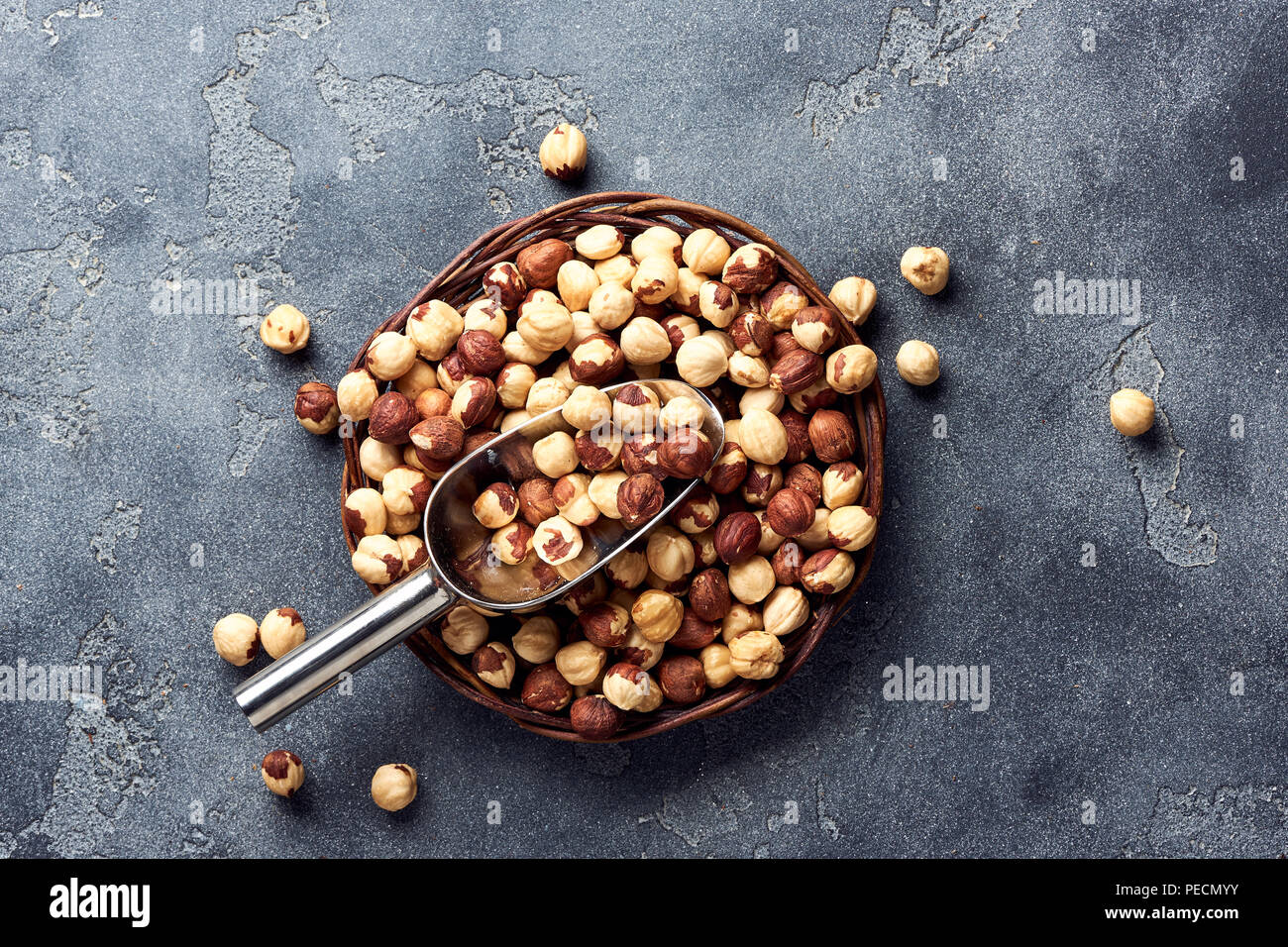 Hazelnuts and scoop on gray background Stock Photo