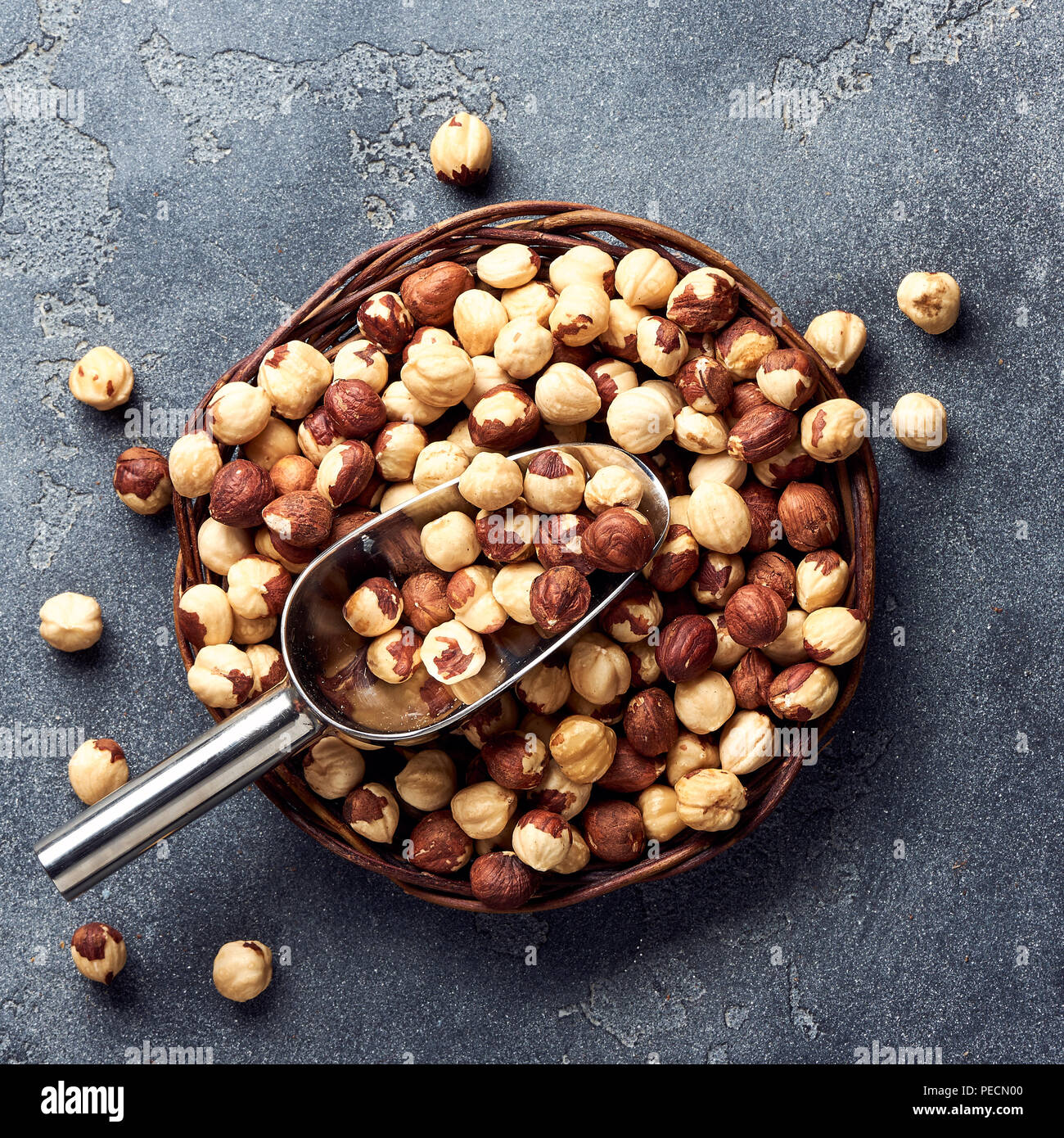 Hazelnuts and scoop on gray background Stock Photo