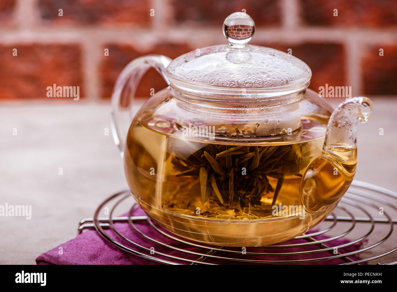 Glass teapot with tea on cooling rack. Front view Stock Photo Alamy