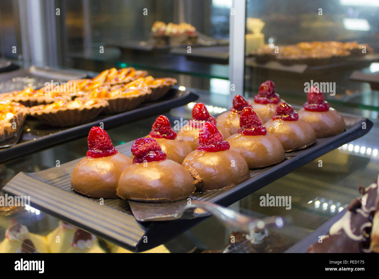 Turkish dessert, cake in sweet syrup with a fresh raspberries Stock