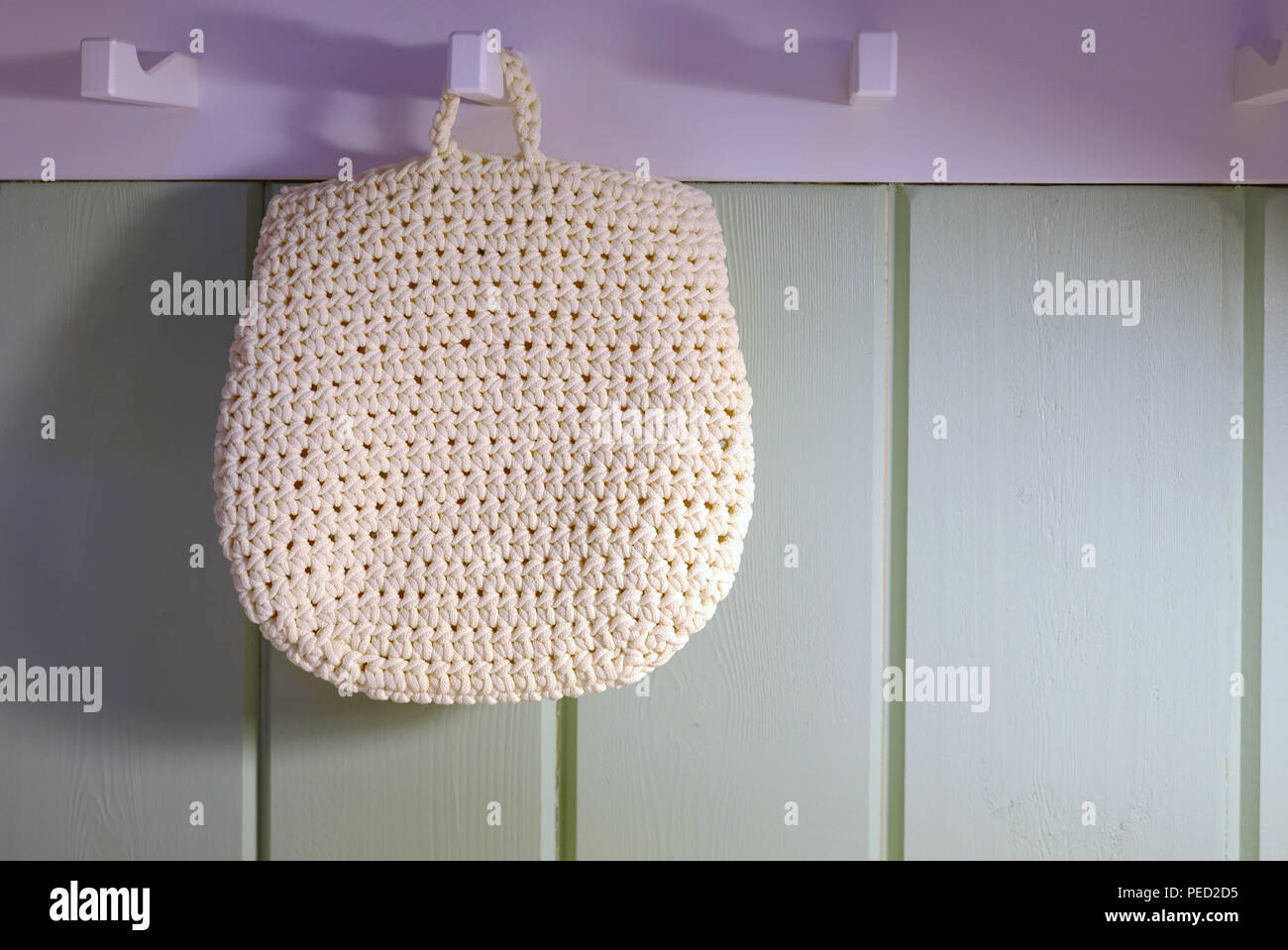 Roll towels with wicker basket on a shelf in the background stand. Bathroom interior design. Stock Photo