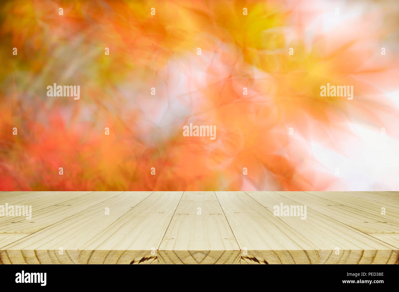 Pine wood counter with blurred autumn leaves background. Stock Photo