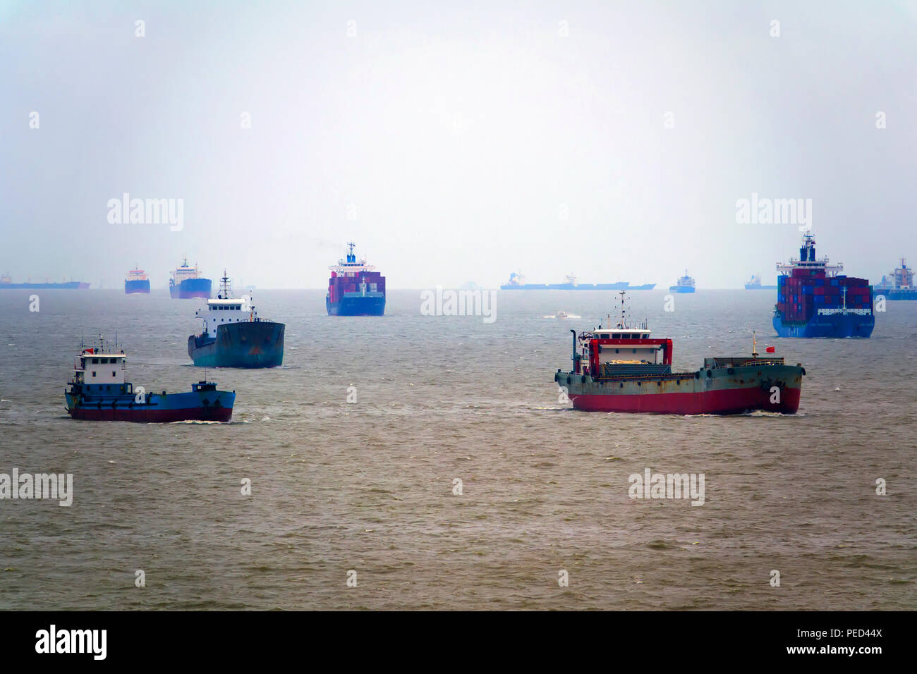 Container ships and fishing boats in Shanghai China Asia East China Sea Yangtze River Delta Stock Photo
