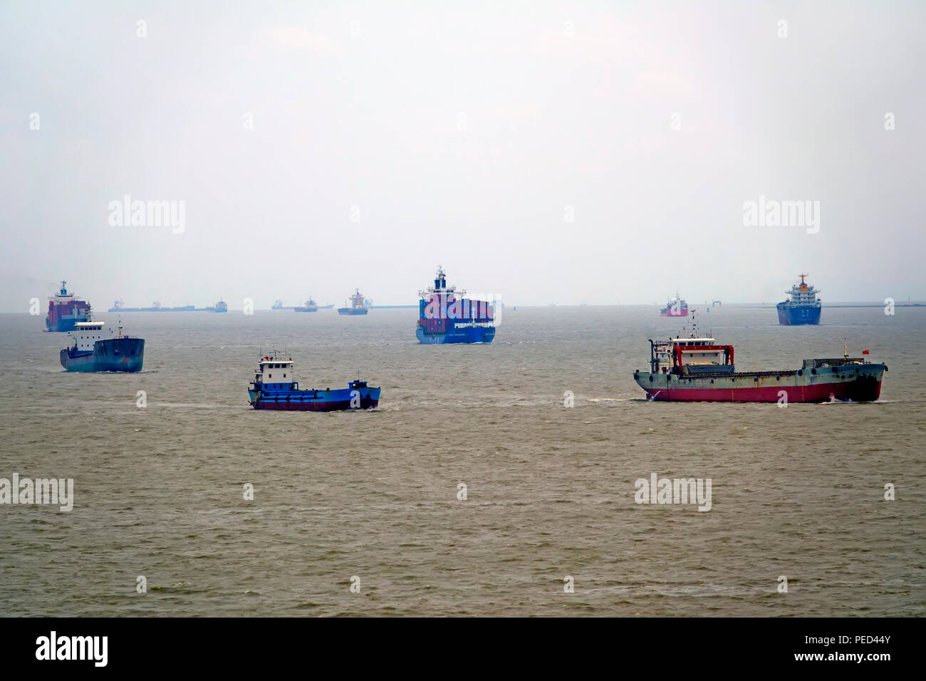 Container ships and fishing boats in Shanghai China Asia East China Sea Yangtze River Delta Stock Photo
