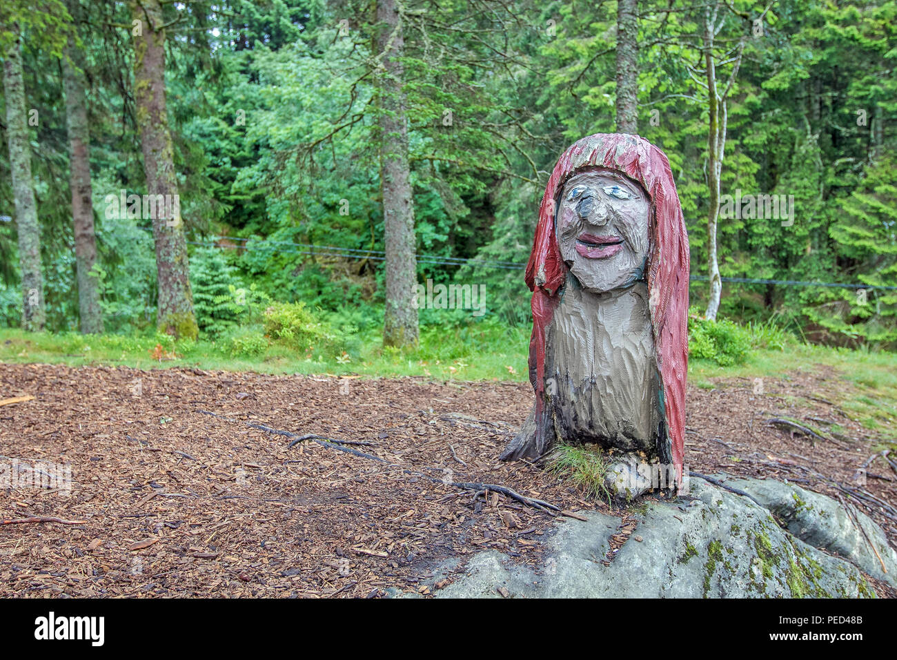 Wooden carved sculpture of a troll at a small park in Bergen, Norway, dedicated for kids. Stock Photo