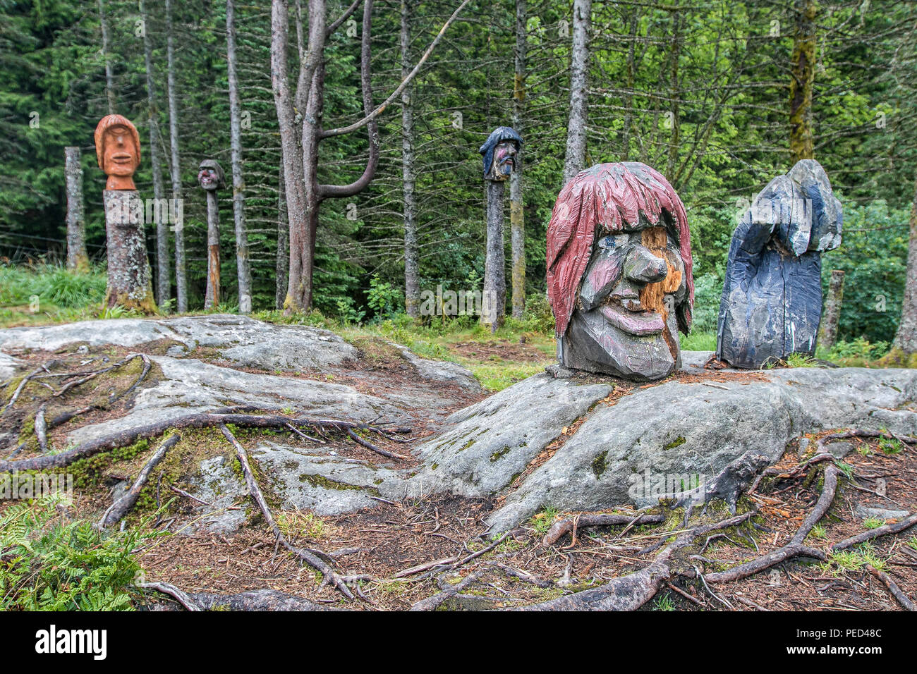 Wooden carved sculptures trolls at a small park in Bergen, Norway, dedicated for kids. Stock Photo