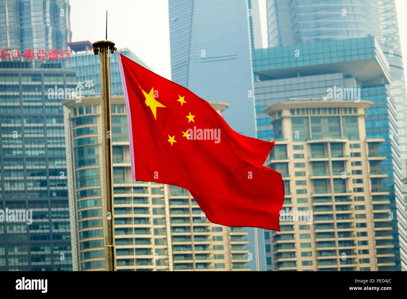 Flag of People's Republic of China in Shanghai Communist Party with Skyline in background Stock Photo