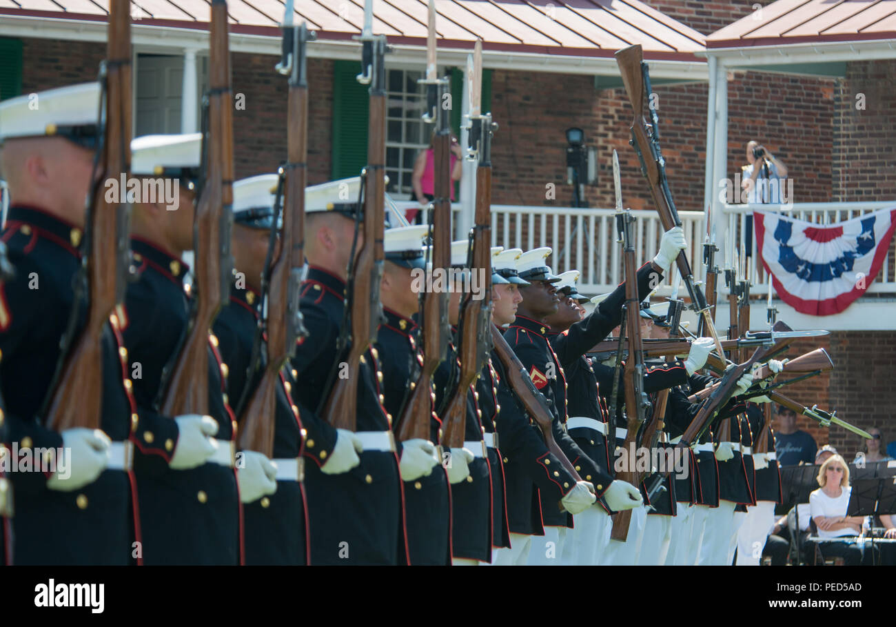 Members of the Marine Corps Silent Drill Platoon perform during the Fort McHenry for the Sea Services Ceremony Aug. 1, 2015. The ceremony celebrated the 100th anniversary of the Coast Guard with a concert by the Chesapeake Concert Band, precision rifle drill by the Marine Corps Silent Drill Platoon, demonstration of hand-to-hand combat exercises, and fife and drum music from the War of 1812 by the Fort McHenry Guard. (U.S. Coast Guard photo by Petty Officer 2nd Class David R. Marin) Stock Photo