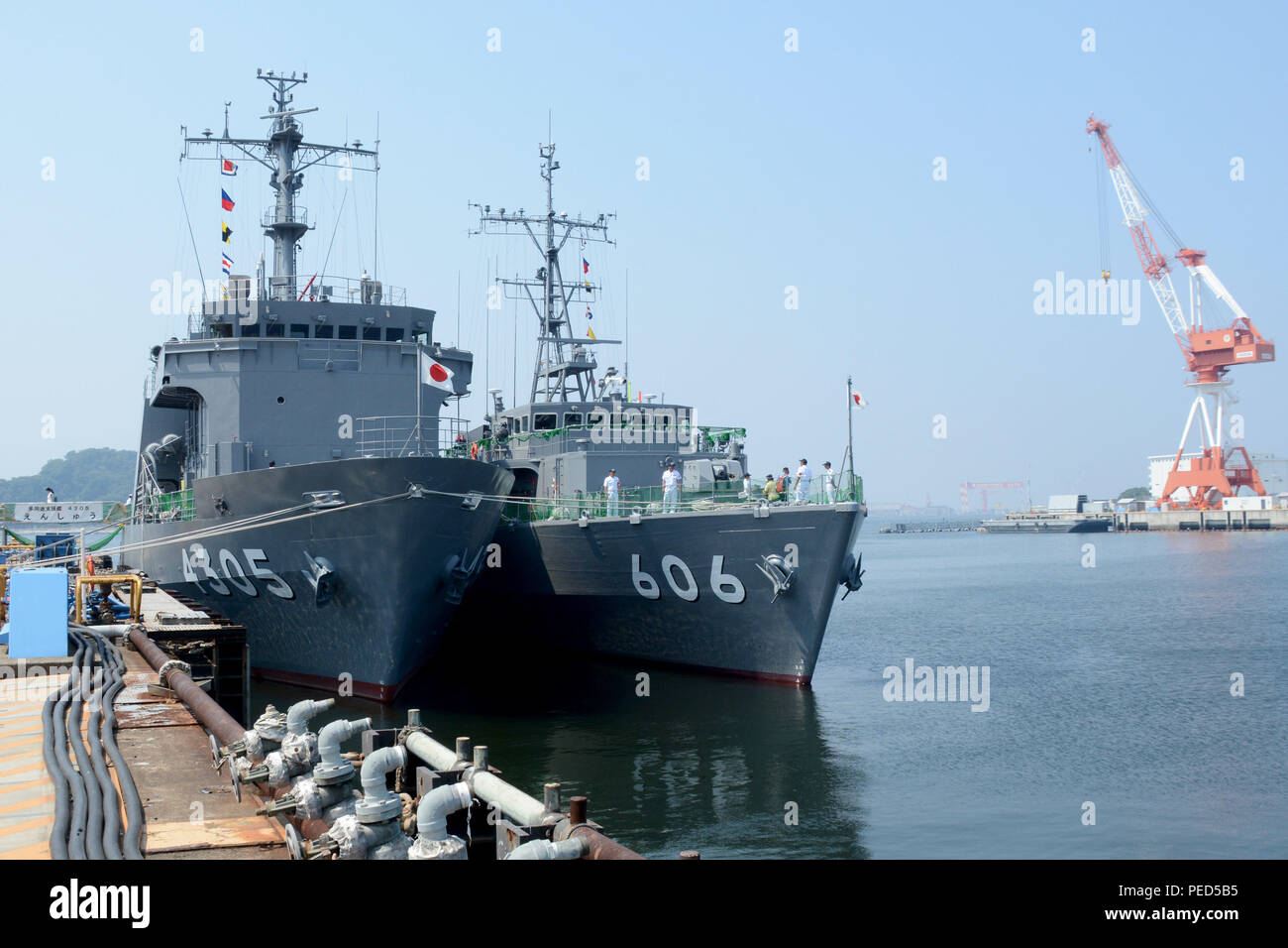 150801-N-XN177-453 YOKOSUKA, Japan (August 1, 2015) The Japanese Maritime Self Defense Force (JMSDF) Support Ship Enshu (AMS 4305) and the Enoshima-class minesweeper Hatsushima (MSC 606) sit pier-side at Commander Fleet Activities Yokosuka (CFAY) during Yokosuka Friendship Day 2015. Friendship Day allows local citizens an up close look at U.S. Navy personnel and equipment at CFAY. CFAY provides, maintains, and operates base facilities and services in support of 7th Fleet’s forward-deployed naval forces, 83 tenant commands, and 24,000 military and civilian personnel. (U.S. Navy photo by Mass Co Stock Photo