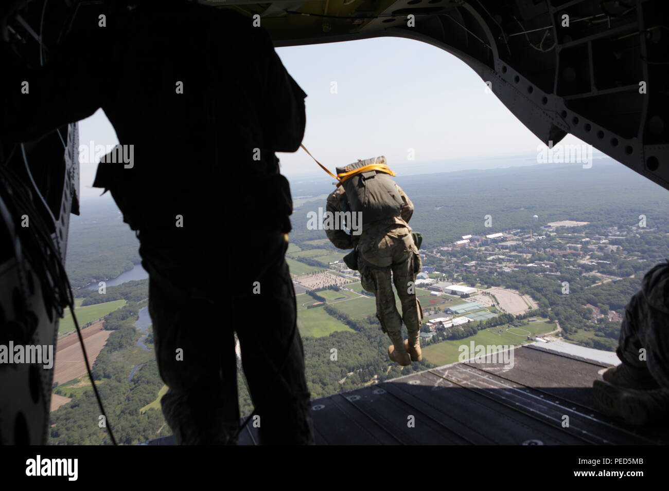 U.S. Army Sgt. Austin Berner from the 982 COMCAM and his team from the United Kingdom jump from a CH-47 helicopter at Leapfest 2015, Aug. 1, 2015.  Leapfest is an International parachute competition hosted by the 56th Troop Command, Rhode Island National Guard to promote high level technical training and esprit de corps within the International Airborne community. (U.S. Army Photo by Sgt. 1st Class Horace Murray/Released) Stock Photo