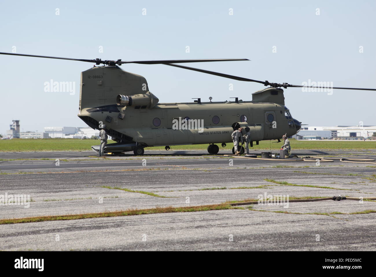 A U.S. Army CH-47 Chinook helicopter stops off at Quonset Air National Guard Base for refueling by Soldiers from the 126 Aviation Regiment, R.I. National Guard, during Leapfest 2015, Aug. 1, 2015. Leapfest is an International parachute competition hosted by the 56th Troop Command, Rhode Island National Guard to promote high level technical training and esprit de corps within the International Airborne community. (U.S. Army Photo by Sgt. 1st Class Horace Murray/Released) Stock Photo