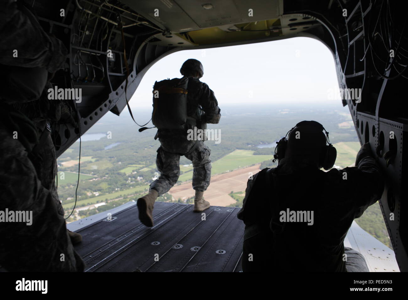 U.S. Army Master Sgt. Tommy O'Hare from the Special Operations Detachment Global, R.I. National Guard, gives the 'GO' signal U.S. Army Soldiers aboard a CH-47 Chinook, Aug. 1, 2015. Leapfest is an International parachute competition hosted by the 56th Troop Command, Rhode Island National Guard to promote high level technical training and esprit de corps within the International Airborne community. (U.S. Army Photo by Sgt. 1st Class Horace Murray/ Released) Stock Photo