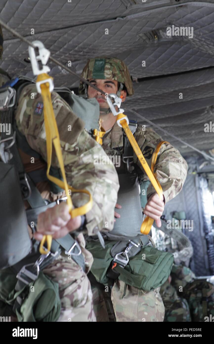 U.S. Army Sgt. Austin Berner from the 982 COMCAM stands by as he is ready to exit a CH-47 helicopter with his team from the United Kingdom at Leapfest 2015, Aug. 1, 2015. Leapfest is an International parachute competition hosted by the 56th Troop Command, Rhode Island National Guard to promote high level technical training and esprit de corps within the International Airborne community. (U.S. Army Photo by Sgt. 1st Class Horace Murray/ Released) Stock Photo