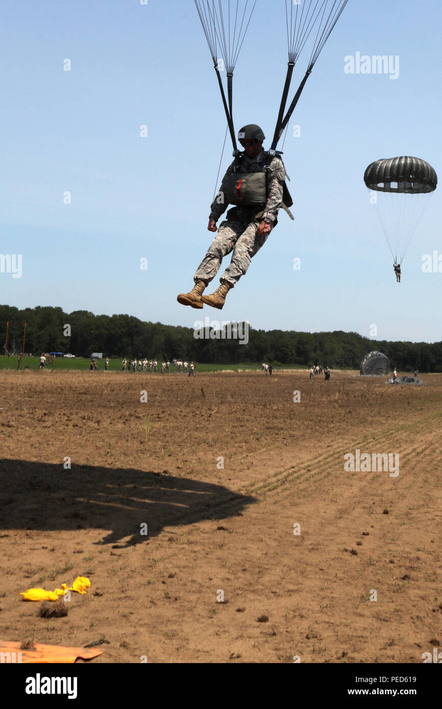 U.S. Army paratroopers parachute onto the drop zone during Leapfest 2015 in West Kingston, R.I., Aug. 1, 2015. Leapfest is an International parachute competition hosted by the 56th Troop Command, Rhode Island National Guard to promote high level technical training and esprit de corps within the International Airborne community. (U.S. Army Photo by Spc. Joseph Cathey/ Released) Stock Photo