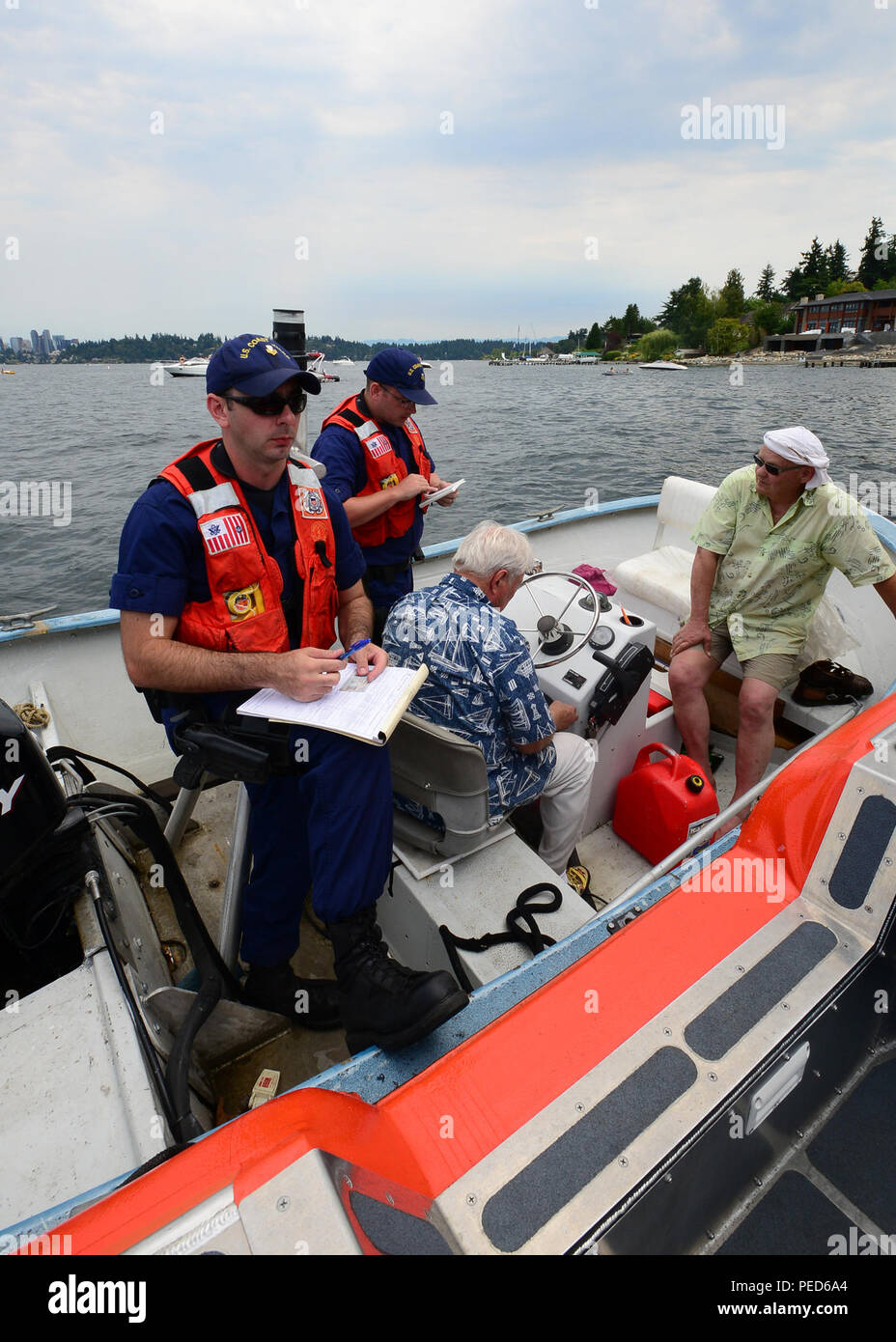 Coast Guard Petty Officer 1st Class Daniel Hayes (far left) and Petty Officer 1st Class James
