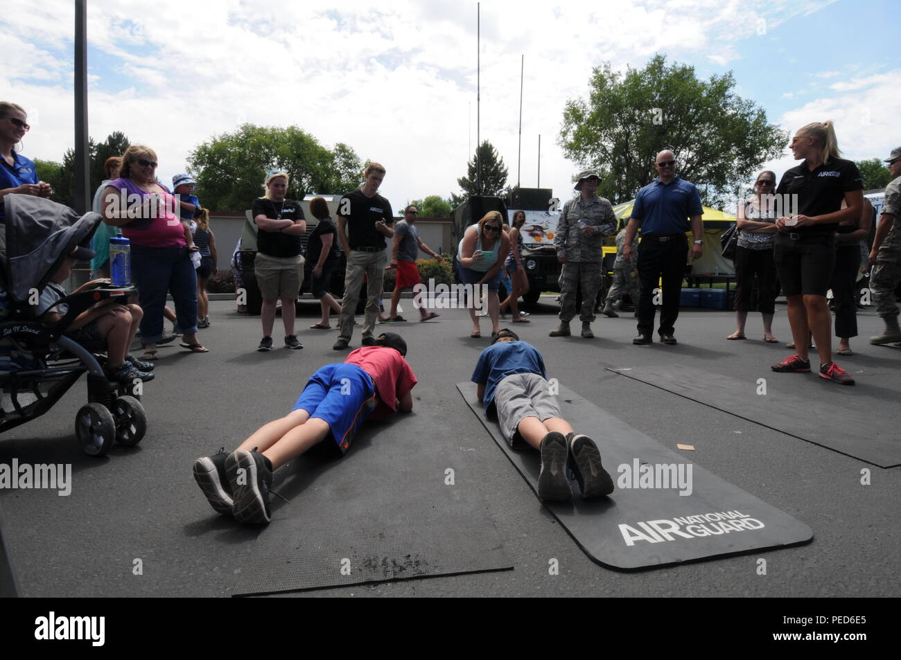 Community members participate in a planking competition hosted by the Air National Guard Recruiters during an open house at the Sentry Eagle exercise in Klamath Falls, Ore., Aug. 1, 2015. This year Sentry Eagle featured F-15s, F-16s, F-18s and KC-135s along with static displays and multiple entertainment booths during the Air National Guard's largest air-to-air training exercise. (U.S. Air National Guard photo by Senior Airman Penny Snoozy/Released) Stock Photo