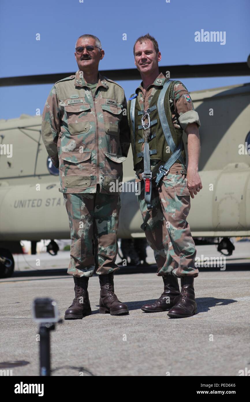 South African Lt. Cols. Laurel Thatcher and Skillie Le Roux take a picture at Quanset Air National Guard Base during a refueling stop with a U.S. Army CH-47 Chinook during the international wing exchange jump, Aug. 3, 2015.  Leapfest is an International parachute competition hosted by the 56th Troop Command, Rhode Island National Guard to promote high level technical training and esprit de corps within the International Airborne community. (U.S. Army Photo by Sgt. 1st Class Horace Murray/Released) Stock Photo