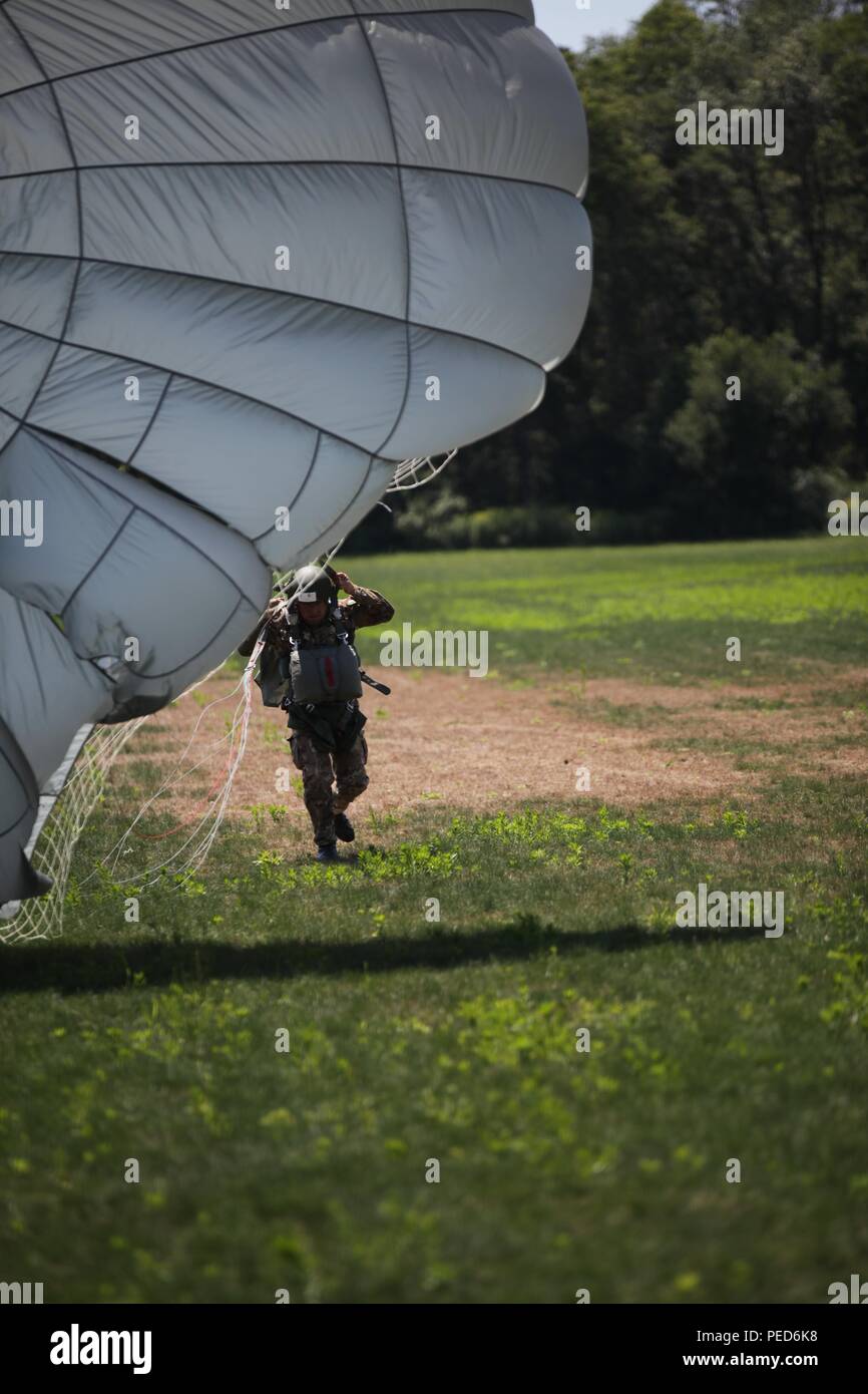 An Italian paratrooper gains control of his MC-6 parachute after landing at West Kingston, R.I. during a wing exchange jump, Aug. 3, 2015. Leapfest is an International parachute competition hosted by the 56th Troop Command, Rhode Island National Guard to promote high level technical training and esprit de corps within the International Airborne community. (U.S. Army Photo by Sgt. 1st Class Horace Murray/Released) Stock Photo