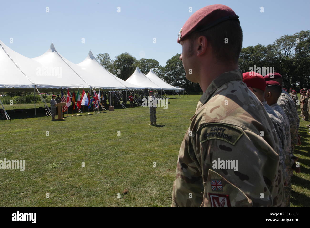 The wing pinning ceremony is seen over the shoulder of United Kingdom paratrooper Cpl. Jim Christie from the 7th PARA, Royal Horse Artillery, during the wing exchange ceremony in West Kingston, R.I., Aug. 3, 2015.  Leapfest is an International parachute competition hosted by the 56th Troop Command, Rhode Island National Guard to promote high level technical training and esprit de corps within the International Airborne community. (U.S. Army Photo by Sgt. 1st Class Horace Murray/Released) Stock Photo