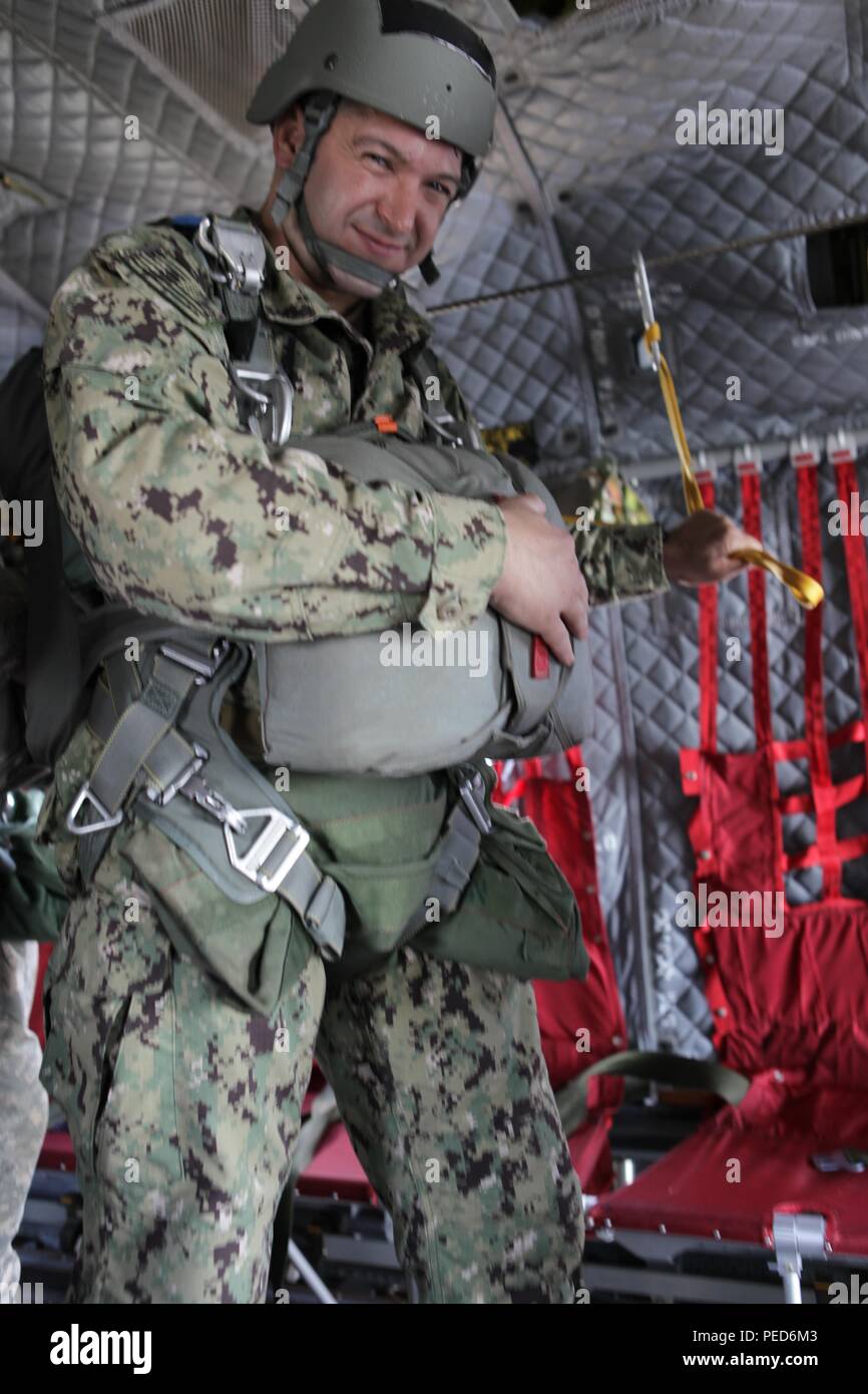 U.S. Navy Lt. Bryan Stern stands ready to jump from a U.S. Army Chinook helicopter during the international wing exchange jump, Aug. 3, 2015. Leapfest is an International parachute competition hosted by the 56th Troop Command, Rhode Island National Guard to promote high level technical training and esprit de corps within the International Airborne community. (U.S. Army Photo by Sgt. 1st Class Horace Murray/Released) Stock Photo