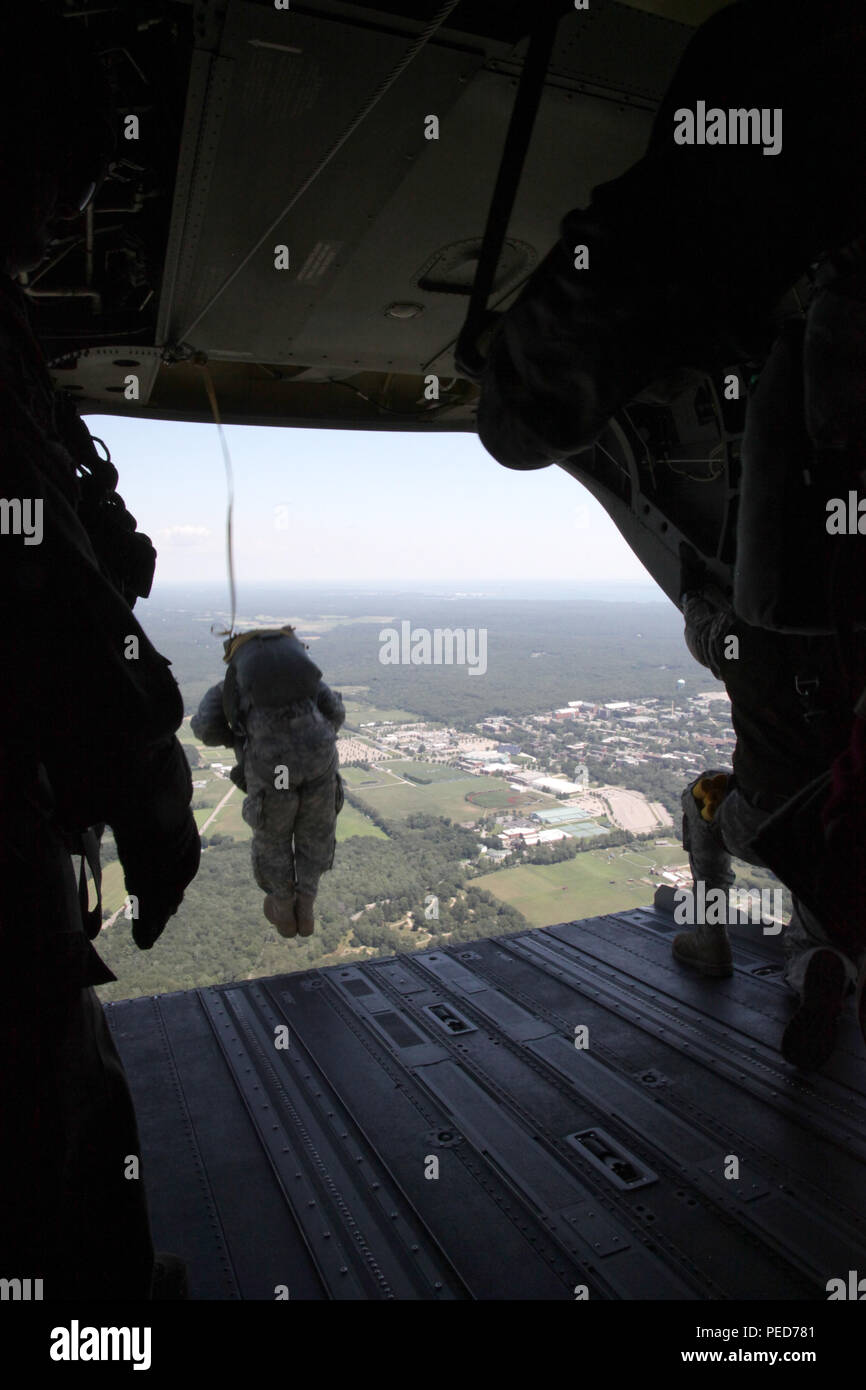 A U.S Army paratrooper takes part in a wing exchange jump from a CH-47 Chinook helicopter at Leapfest in West Kingston, R.I., Aug. 3, 2015. Leapfest is an International parachute competition hosted by the 56th Troop Command, Rhode Island National Guard to promote high level technical training and esprit de corps within the International Airborne community. (U.S. Army Photo by Spc. Josephine Carlson/Released) Stock Photo