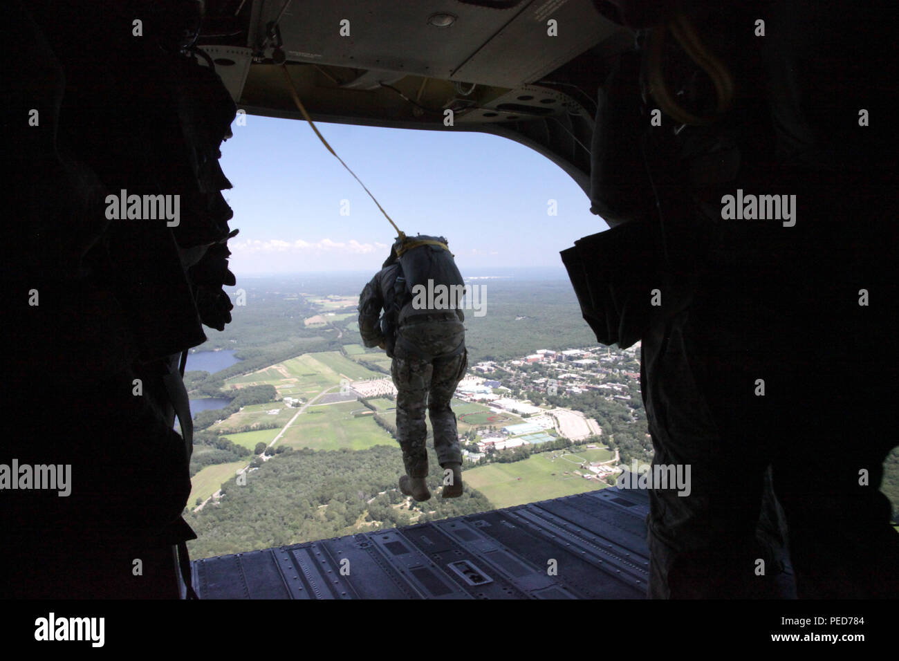 A U.S. Army paratrooper jumps from a CH-47 Chinook helicopter during the wing exchange at Leapfest in West Kingston, R.I., Aug. 3, 2015. Leapfest is an International parachute competition hosted by the 56th Troop Command, Rhode Island National Guard to promote high level technical training and esprit de corps within the International Airborne community. (U.S. Army Photo by Spc. Josephine Carlson/Released) Stock Photo