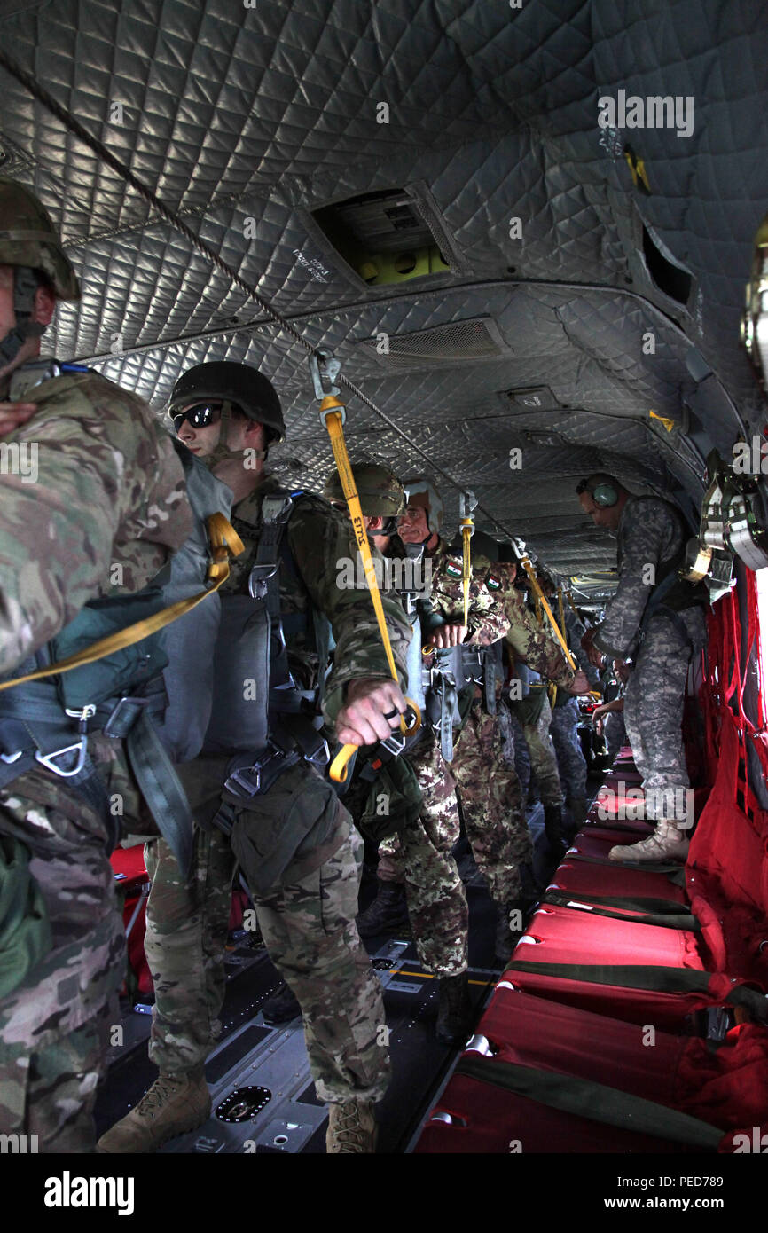 Paratroopers wait to jump from a CH-47 Chinook helicopter during the wing exchange at Leapfest in West Kingston, R.I., Aug. 3, 2015. Leapfest is an International parachute competition hosted by the 56th Troop Command, Rhode Island National Guard to promote high level technical training and esprit de corps within the International Airborne community. (U.S. Army Photo by Spc. Josephine Carlson/Released) Stock Photo