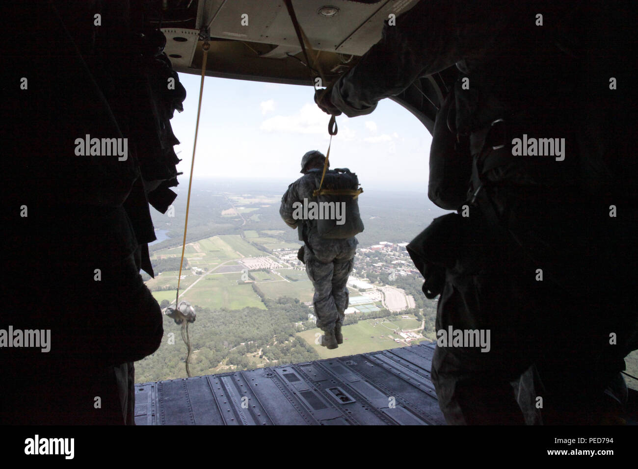 A U.S. Army paratrooper jumps from a CH-47 Chinook helicopter at Leapfest during the wing exchange jump in West Kingston, R.I., Aug. 3, 2015. Leapfest is an International parachute competition hosted by the 56th Troop Command, Rhode Island National Guard to promote high level technical training and esprit de corps within the International Airborne community. (U.S. Army Photo by Spc. Josephine Carlson/Released) Stock Photo