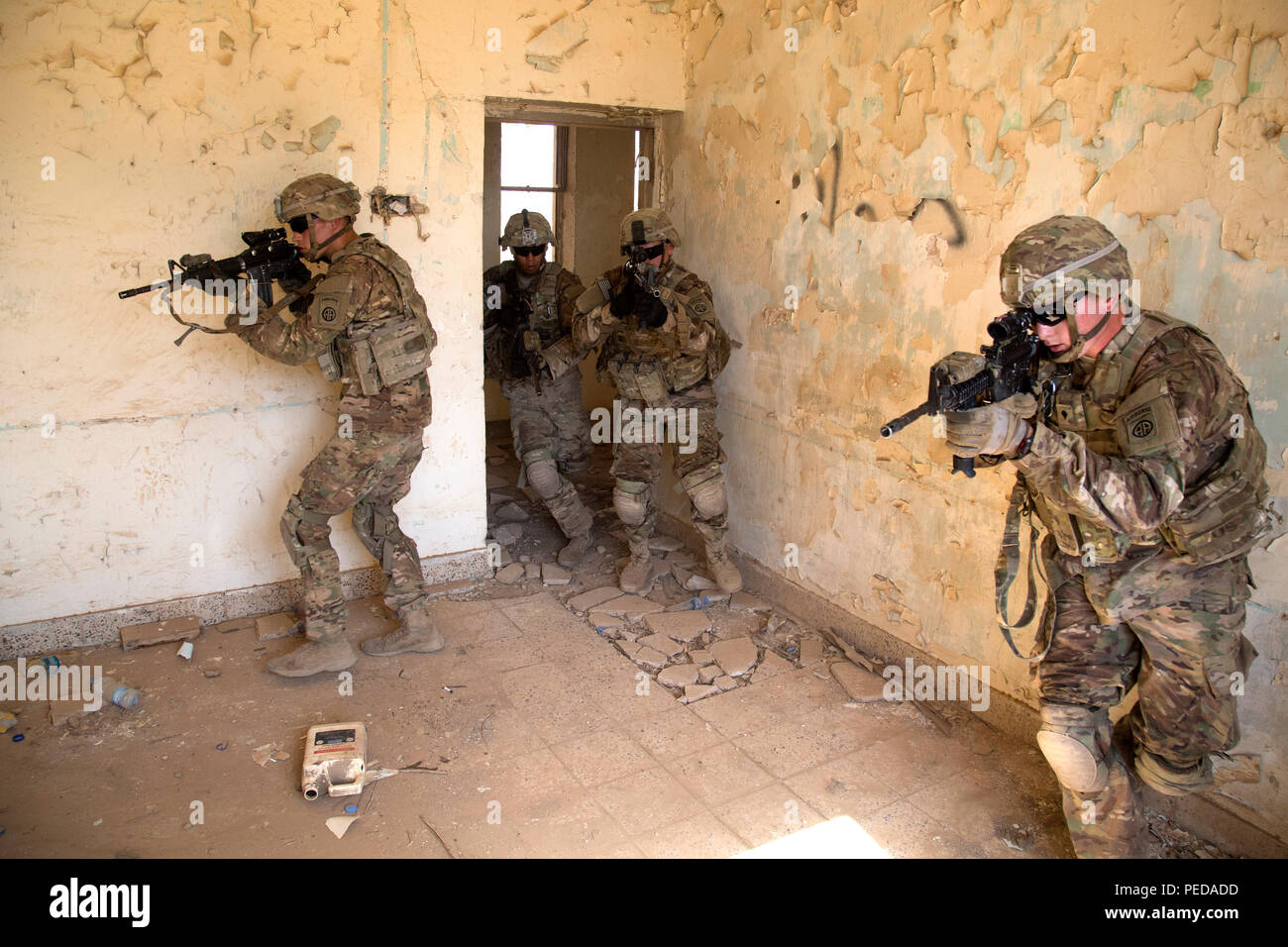 U. S. paratroopers assigned to Bravo Troop, 5th Squadron, 73rd Cavalry Regiment, 3rd Brigade, 82nd Airborne Division, conduct room clearing during squad level training at Camp Taji, Iraq, Aug. 3, 2015. Coalition forces routinely practice what they plan to teach Iraqi soldiers prior to each round of instruction. Training at the building partner capacity sites is an integral part of Combined Joint Task Force – Operation Inherent Resolve’s multinational effort to train Iraqi security force personnel to defeat the Islamic State of Iraq and the Levant. A coalition of regional and international nati Stock Photo