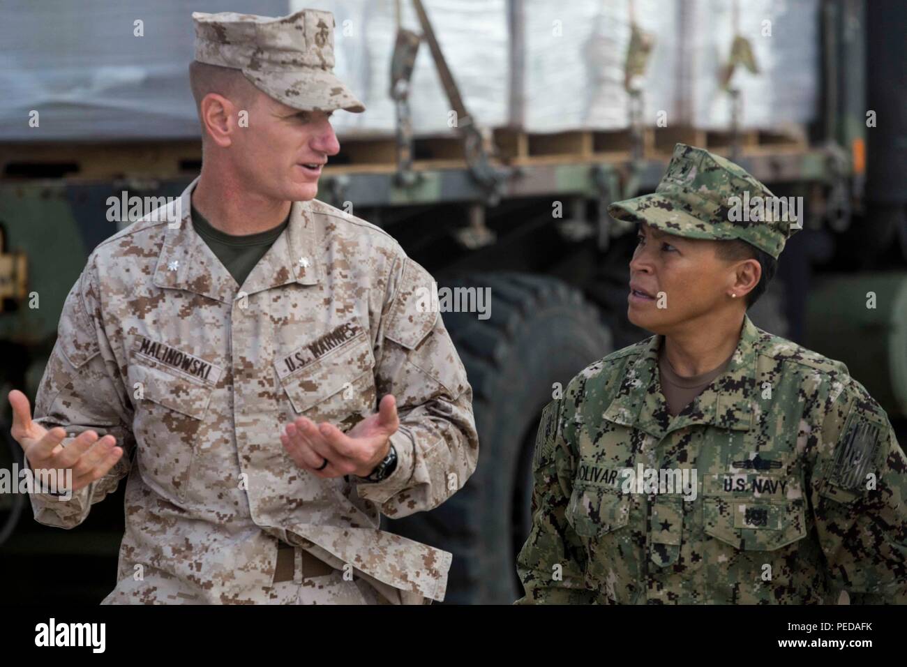 U.S. Marine Lt. Col. Eric Malinowski, the commanding officer of Combat Logistics Battalion 31, 31st Marine Expeditionary Unit, speaks with U.S. Navy Rear Adm. Bette Bolivar, the commander of U.S. Naval Forces Marianas, about typhoon relief efforts in Saipan, Aug. 9, 2015. The Marines and sailors of the 31st MEU and the ships of the Bonhomme Richard Amphibious Ready Group are assisting the Federal Emergency Management Agency with distributing emergency relief supplies to Saipan. Saipan, the most populated island in the Commonwealth of the Northern Mariana Islands, was struck by Typhoon Soudelor Stock Photo