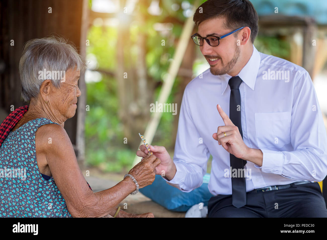 Doctor visit home care older woman and Dispensing of medicine. Healthcare visitor. Stock Photo