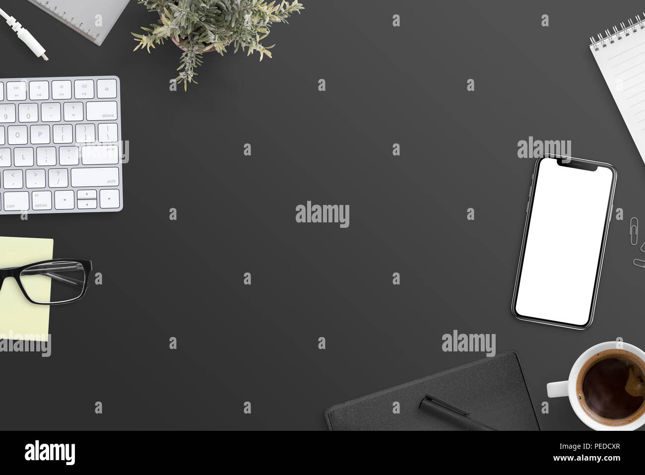 Work desk flat lay concept. Black desk with free space in the middle