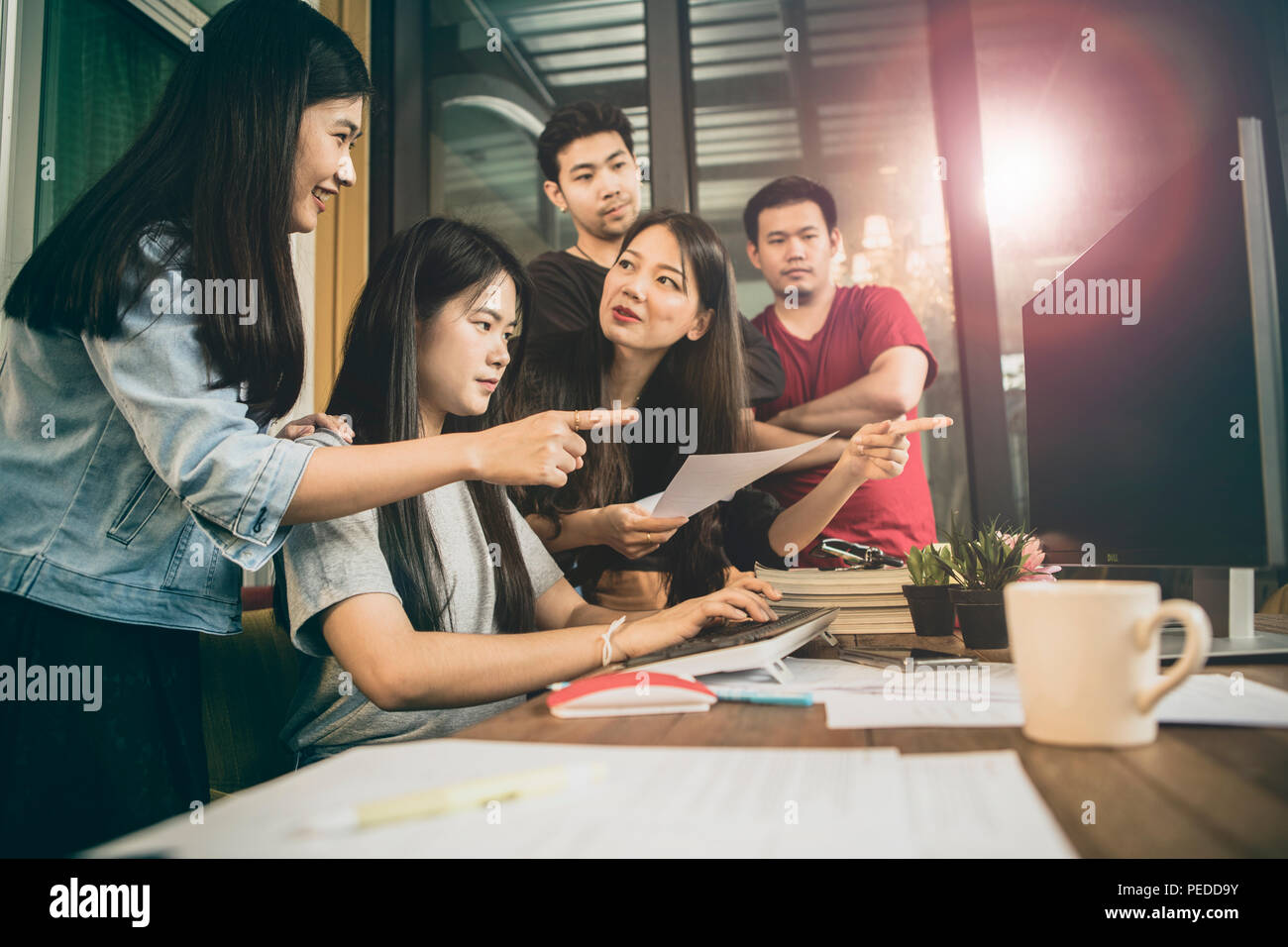 younger asian freelance team meeting for project solution in home office Stock Photo