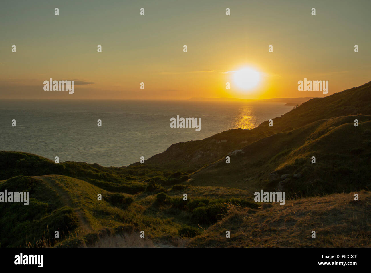 Sun setting over the needles on the Isle of Wight Stock Photo