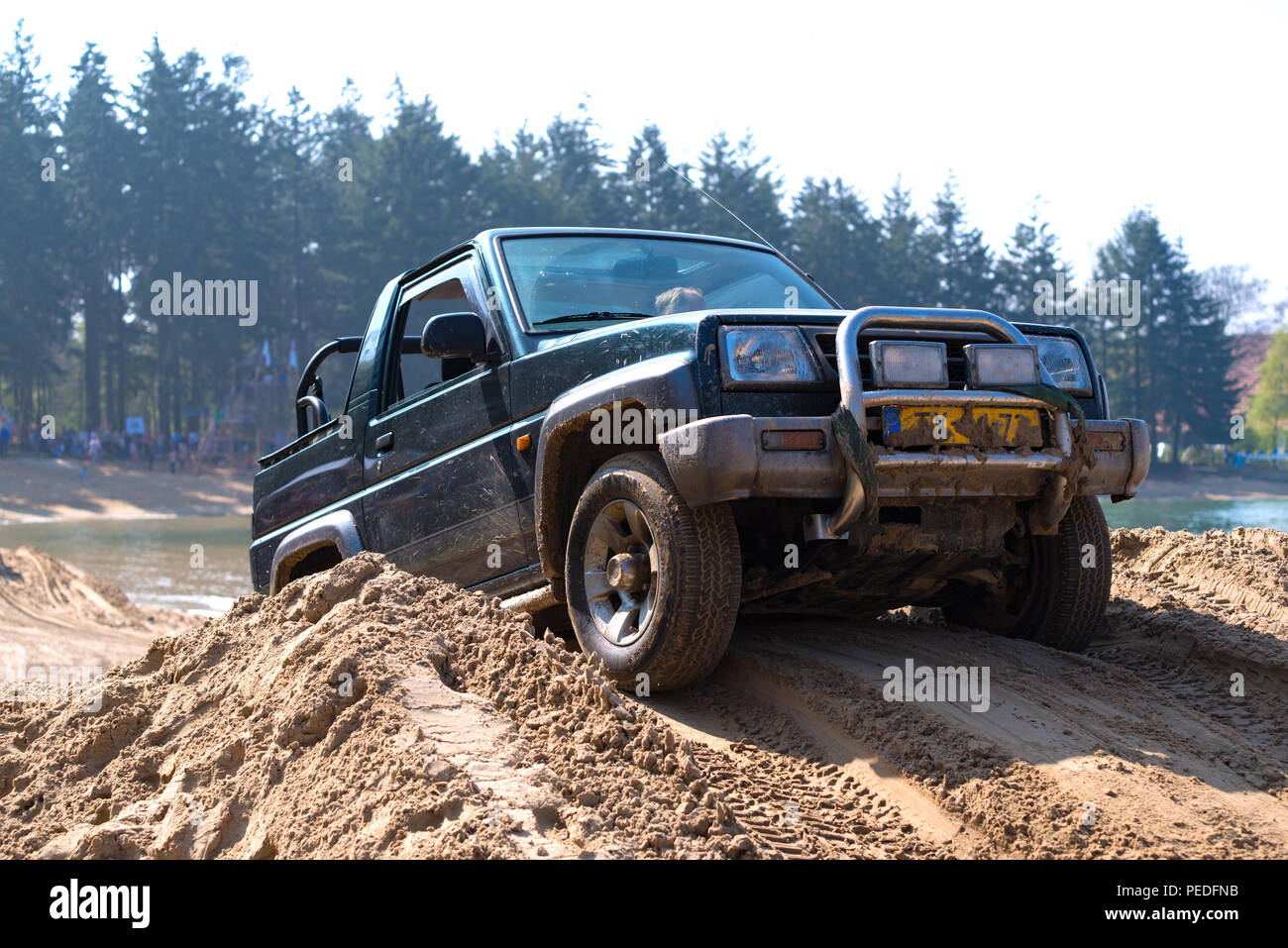 People having fun in an offroad car during an annual event Stock Photo