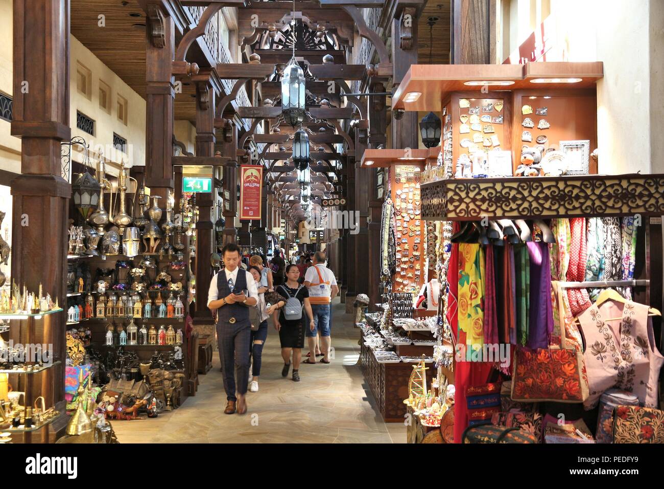 DUBAI, UAE - NOVEMBER 23, 2017: People shop at Souk Madinat Jumeirah in Dubai. The traditional Arab style bazaar is part of Madinat Jumeirah resort. Stock Photo
