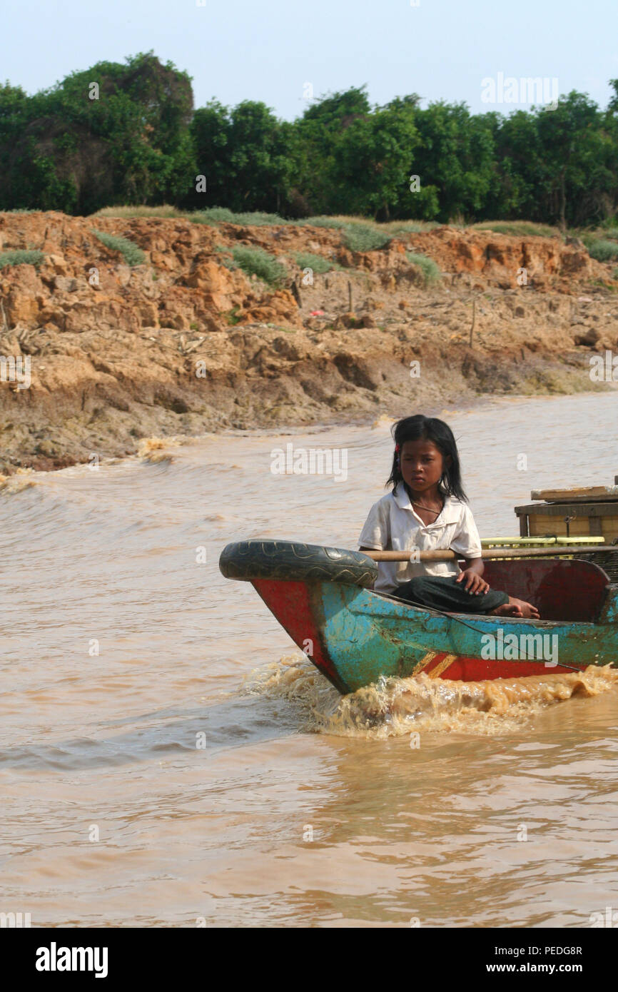 Girl crewing a boat, Tonle Sap River, Siem Reap, Cambodia Stock Photo