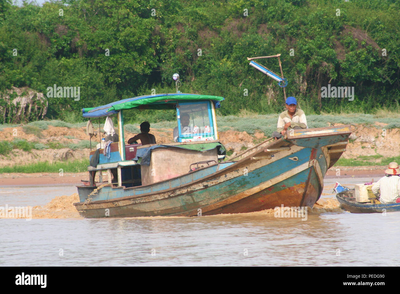 Local fishing boat on Tonle Sap River, Tonle Sap Lake, Siem Reap, Cambodia Stock Photo